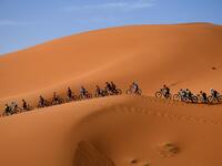 Competitors ride their bikes along sand dunes during the Stage 1 of the 14th edition of Titan Desert 2019 mountain biking race around Merzouga in Morocco on April 28, 2019.  FRANCK FIFE / AFP