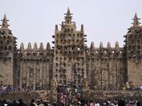 People take part in the annual rendering of the Great Mosque of Djenne in central Mali  MICHELE CATTANI / AFP
