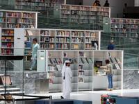 People walk through the aisles of the Qatar National Library in the capital.  KARIM JAAFAR / AFP