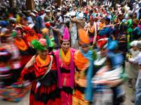 Kalash women wearing traditional dresses dance as they celebrate 'Joshi', a festival to welcome the arrival of spring, at Bumburate village in the mountainous valleys in northern Pakistan.  AAMIR QURESHI / AFP
