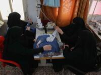 Colleagues of Hasna Dbeis (unseen), a 30-year-old former detainee in a Syrian-regime jail, work at a sewing workshop employing former female detainees, in the town of Maarat Nasrin, in the rebel-held part of the Syrian Idlib  Aaref WATAD / AFP