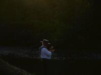 A pilgrim walks by an effigy of a Virgin near the Quema river in Villamanrique, during a pilgrimage to the village of El Rocio. CRISTINA QUICLER / AFP