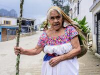 Mexican artisan of the Otomi ethnic group Josefina Jose Tavera, 87, walks in San Nicolas Village, in Tenango de Doria, Hidalgo state, Mexico.  Pedro PARDO / AFP
