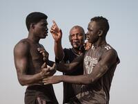 Sudanese wrestlers fight during a traditional Nuba wrestling match at the Haj Youssef stadium in the district of Khartoum.  Yasuyoshi CHIBA / AFP