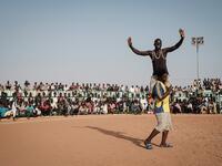 A Sudanese wrestler reacts after winning during a traditional Nuba wrestling match at the Haj Youssef stadium in the district of Khartoum.  Yasuyoshi CHIBA / AFP