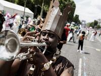People parade during the Tropical Carnival on July, 7 2019 in Paris.  Kenzo TRIBOUILLARD / AFP