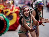 People parade during the Tropical Carnival on July, 7 2019 in Paris.  Kenzo TRIBOUILLARD / AFP