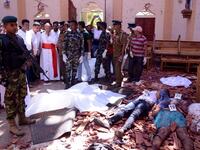 Sri Lanka soldiers and religious members of the parish look on inside the St Sebastian's Church at Katuwapitiya in Negombo on April 21, 2019, following a bomb blast during the Easter service that killed tens of people. STR / AFP