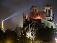 A fire fighter douses the flames during a fire at the Notre-Dame de Paris Cathedral on April 15, 2019, in the French capital Paris. STEPHANE DE SAKUTIN / AFP