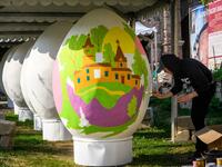 An artist paints a giant Easter egg in the yard of an Orthodox monastery in central Moscow on April 26, 2019, ahead of the Orthodox Easter on April 28, 2019. Russia celebrates the Orthodox Easter on Sunday April 28, 2019. Mladen ANTONOV / AFP