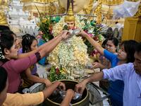 Buddhist devotees pour water at Shwedagone pagoda during Buddha's birthday which falls on the Full Moon Day of Kasone in Yangon, on May 18, 2019.  Sai Aung MAIN / AFP