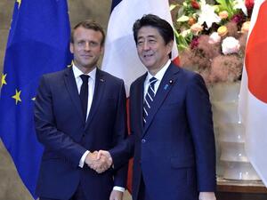  France's President Emmanuel Macron (L) shakes hands with Japan's Prime Minister Shinzo Abe prior to the Japan-France summit at Abe's official residence in Tokyo on June 26, 2019.