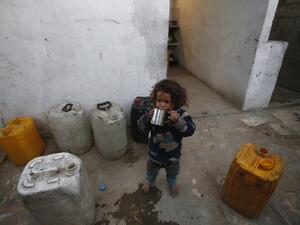 An empoverished Palestinian child drinks water on May 13, 2019 in the southern Gaza Strip refugee camp of Khan Yunis. (MOHAMMED ABED / AFP)