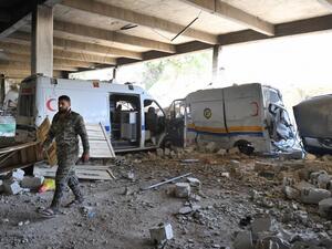 A Syrian government soldier walks past destroyed ambulances and vehicles of the Syrian Civil Defence, also known as "The White Helmets" at their captured former headquarters in the town of Qalaat al-Madiq, some 45 kilometres northwest of the central city of Hama, on May 17, 2019. (AFP/ File)