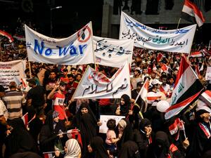 Iraqi followers of Shiite Muslim cleric Moqtada al-Sadr demonstrate in the capital Baghdad's central Tahrir Square late on May 24, 2019, against the involvement in any conflict between Iran and the United States. (AHMAD AL-RUBAYE / AFP)