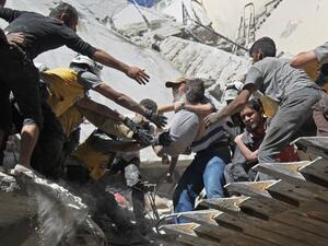 White Helmet rescue volunteers and civilians rescue a child from the rubble of a building destroyed during an air strike by Syrian regime forces and their allies on the town of Ariha, in the southern outskirts of Syria's Idlib province on May 27, 2019. (Amer ALHAMWE / AFP)
