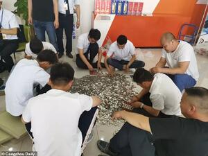 In the end, the customer paid 131,492 yuan (£15,033) in coins and the rest by e-transfer. (Daily Mail)