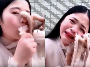 Woman tries to eat octopus alive, nearly gets face ripped. (Video Screenshot)