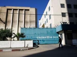 A Palestinian man walks past the building of the UNRWA headquarters in Gaza City on January 8, 2018. (MOHAMMED ABED/AFP/Getty Images) 