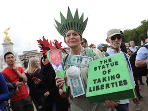 A woman protests outside Buckingham Palace in central London on June 3, 2019, on the first day of the US Presidential three-day State Visit to the UK. (AFP/ File)
