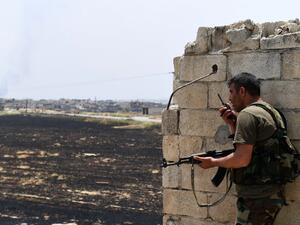 A fighters with the Syrian regime forces holds a position in the town of Jalamah in Syria's Hama governorate during clashes with jihadists on June 8, 2019. (George OURFALIAN / AFP)