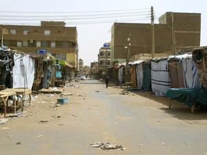 A Sudanese man walks past closed shops and makeshift stalls at the Omdurman market, in Khartoum's twin city on June 9, 2019. (AFP)