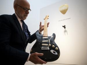 Kerry Keane, Christie's Musical Instruments Specialist holds the "Black Strat" (Fender Stratocaster, 1969) from David Gilmour at Christie's on June 14, 2019 in New York City. (AFP)