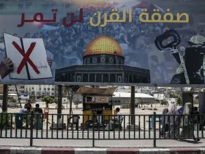 A picture taken on June 16, 2019, shows a poster in Gaza City denouncing the US Middle East peace plan dubbed the "deal of the century". Arabic writing on poster reads "The deal of the century will not pass".  (MAHMUD HAMS / AFP)