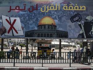 A picture taken on June 16, 2019, shows a poster in Gaza City denouncing the US Middle East peace plan dubbed the "deal of the century". Arabic writing on poster reads "The deal of the century will not pass".  (MAHMUD HAMS / AFP)