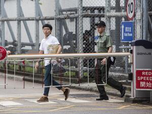 Hong Kong democracy activist Joshua Wong (L) leaves Lai Chi Kok Correctional Institute in Hong Kong on June 17, 2019. Wong called on the city's pro-Beijing leader Carrie Lam to resign after he walked free from prison, as historic anti-government protests rocked the city. (ISAAC LAWRENCE / AFP)