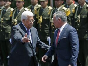 Jordan's King Abdullah II (right) speaks with Palestinian Authority President Mahmoud Abbas upon his arrival in the West Bank city of Ramallah on August 7, 2017. (AFP/ ABBAS MOMANI)