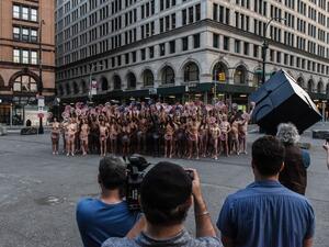 People are directed by artist Spencer Tunick to pose nude holding cut outs of nipples during a photo shoot on June 2, 2019 in New York City. Spencer Tunick staged his photo shoot in front of the Facebook building in Manhattan to protest Facebook and Instagram's ban on showing the female nipple. (AFP)