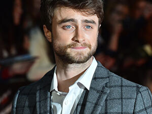 British actor Daniel Radcliffe poses for photographers on the red carpet as he arrives for the UK Premier of "Horns" in central London. (AFP)