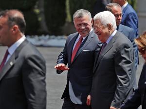 Jordan's King Abdullah II, center, walks Monday with Palestinian leader Mahmoud Abbas. (AHMAD GHARABLI/Getty-AFP )
