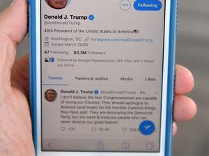 A July 21, 2019 photo of a cell phone showing the Twitter page of US President Donald Trump in Morristown, New Jersey. Trump renewed his attack on four Democratic congresswomen. MANDEL NGAN / AFP