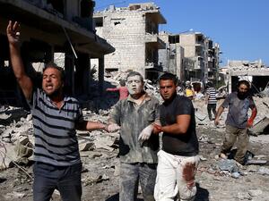 Syrians help a man pulled out from the rubble of a destroyed building following a reported Russian air strike on July 22, 2019 on Maaret al-Numan in Syria's northwestern Idlib province. (AFP/ File Photo)