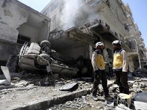 Members of the Syrian Civil Defence (White Helmets) gather at the site of a reported air strike on the town of Ariha, in the south of Syria's Idlib province on July 28, 2019. (Omar HAJ KADOUR / AFP)
