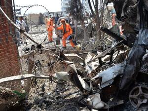 Afghan municipality workers work to clear up the site of an attack in Kabul on July 29, 2019, a day after a deadly assault targeting a political campaign office. (AFP/ File Photo)