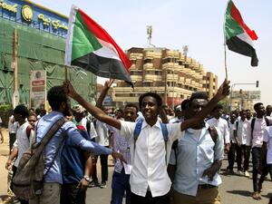 Sudanese students wave national flags as they protest in the capital Khartoum on July 30, 2019, a day after teenagers were shot at a rally. (AFP/ File Photo)