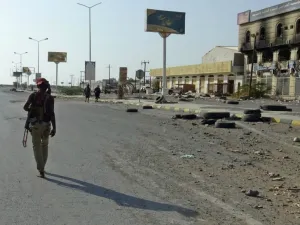 A Yemeni pro-government fighter walks with a rifle in the Houthi-held Red Sea port city of Hodeida. (AFP/ File Photo)