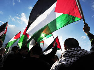 Palestinians carry Palestinians flags (Shutterstock)	