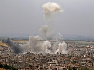 Smoke rising following reported Syrian government forces' bombardment on the town of Khan Sheikhun in the southern countryside of the rebel-held Idlib province (AFP)