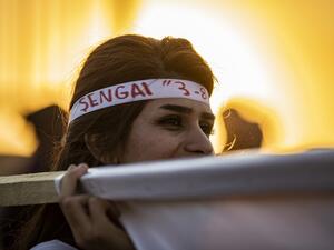 A Syrian Yazidi woman takes part in a demonstration in the northeastern town of Amude, about 28 kilometres west of Qamishli near the Syrian-Turkish border (AFP)