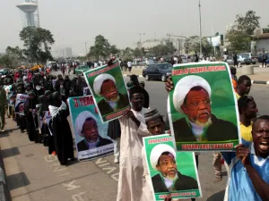 Members of Islamic Movement in Nigeria take part in a demonstration against the detention of their leader Ibrahim Zakzaky (poster), in Abuja (AFP)