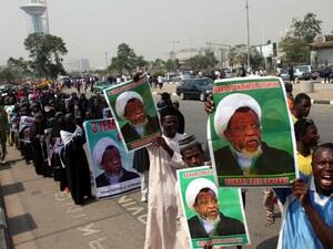 Members of Islamic Movement in Nigeria take part in a demonstration against the detention of their leader Ibrahim Zakzaky (poster), in Abuja (AFP)