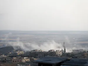 A smoke billowing above buildings during a reported air strike by pro-regime forces on Khan Sheikhun in the south of the northwestern Syrian province of Idlib. (AFP)