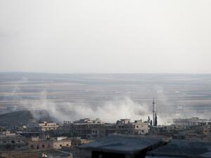 A smoke billowing above buildings during a reported air strike by pro-regime forces on Khan Sheikhun in the south of the northwestern Syrian province of Idlib. (AFP)