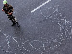 A security personnel stands guard at a roadblock in Jammu (AFP)