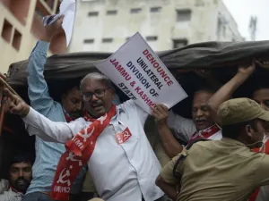 Members of the Communist Party of India are detained by police at a protest in Hyderabad  (AFP)