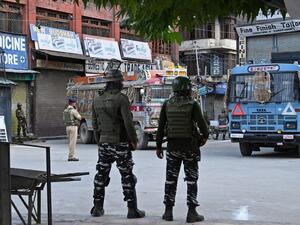 Security personnel stand guard a street during a lockdown in Srinagar on August 12, 2019. (AFP)